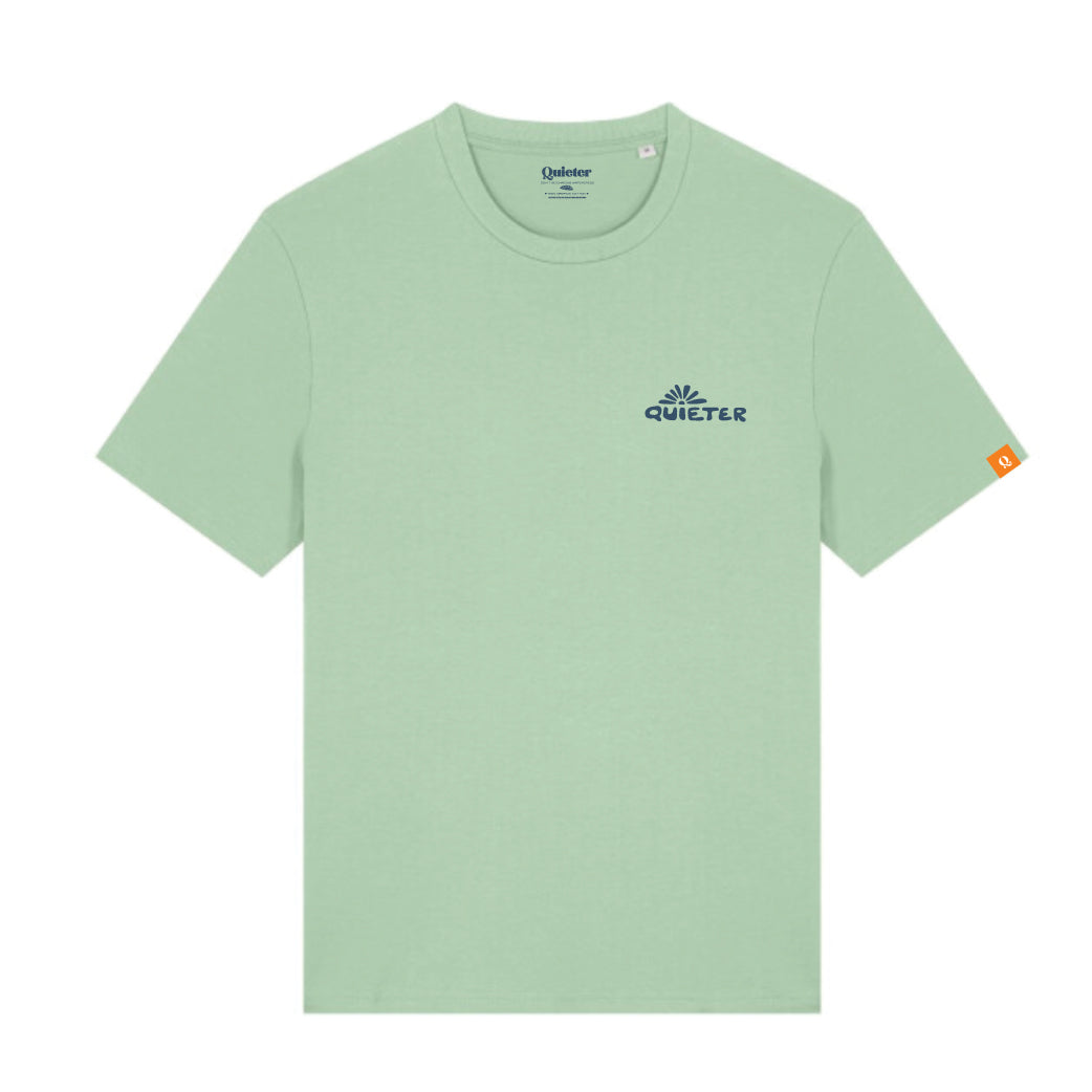 A light sage green short-sleeve t-shirt with a small navy blue Quieter logo on the left chest and a small orange tag on the right sleeve, shown on a plain white background.